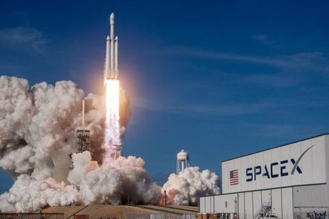 Rocket ship taking off with smoke at SpaceX facility