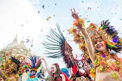 Carnival dancers in front of a church. 