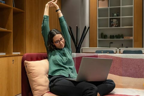 Pessoa fazendo pausa para alongamento no ambiente de trabalho