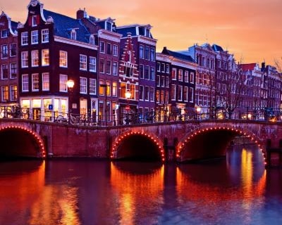 amsterdam - a bridge over a river with a bridge over it