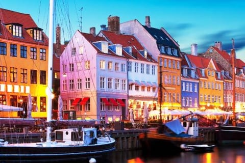 a boat docked in a harbor with a city in the background