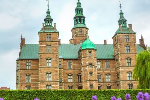 a castle like building with a green roof and a green roof