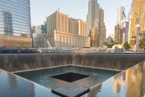 a square shaped fountain with a square shaped object in the middle