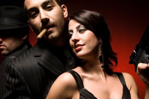 a man and woman in a suit and hat