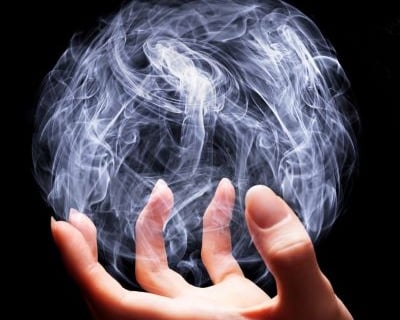 magic - a person holding a ball of smoke on a black background