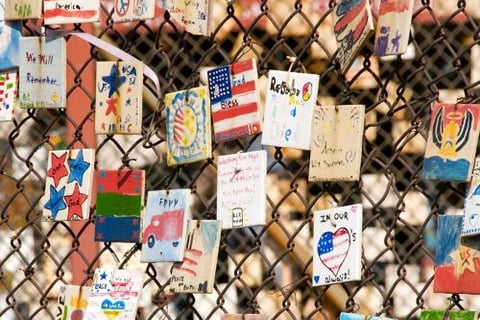 a fenced in area with many cards and pictures