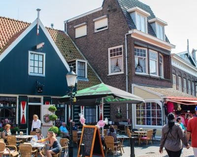 Volendam - a group of people walking down a brick street