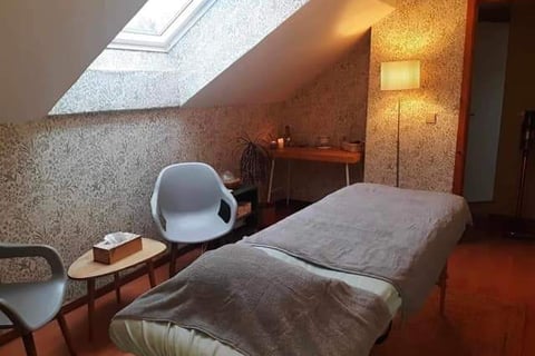 a bedroom with a bed and a chair