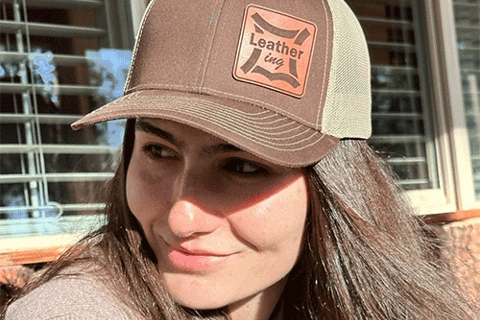 a woman with long hair and a hat on