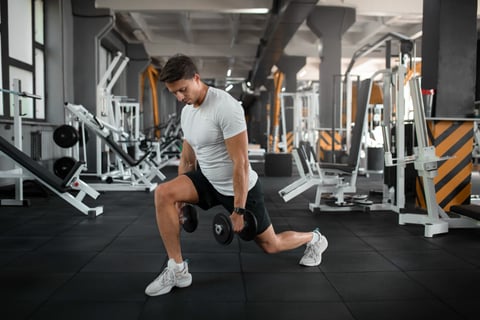 Man doing dumbbell lunges workout