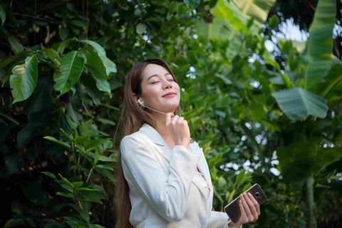 Girl listening to songs in the nature.