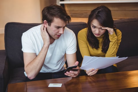 Wife and husband reading foreclosure notice.