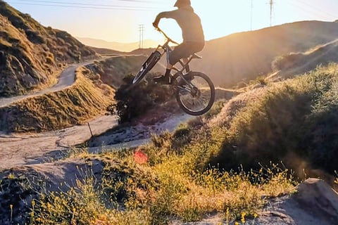 Mountain biker with clean jump form, relaxed knees and centered body
