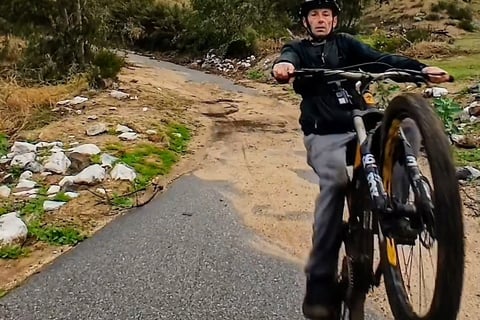 Mountain bike rider practicing manual and wheelie techniques for skill building