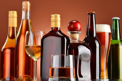 a variety of alcohol bottles and glasses on a table