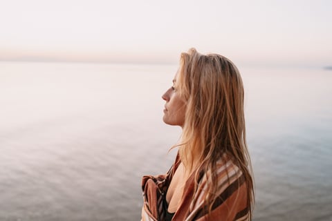 a woman in a blanket blanket on a beach