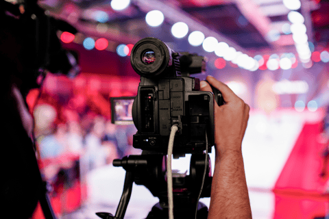 a person holding a camera and recording a fashion show
