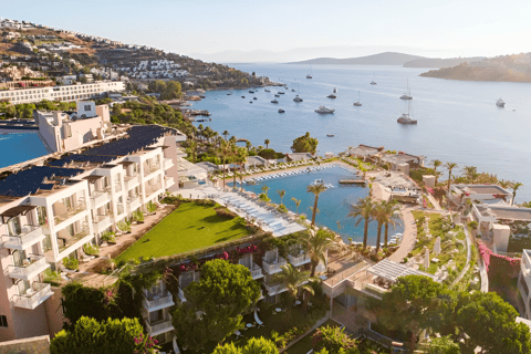 a hotel in front of a large body of water with a lot of boats in it