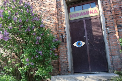 Entry to studies. A large exhibition sign - an eye - is stuck in front of the exhibition. 