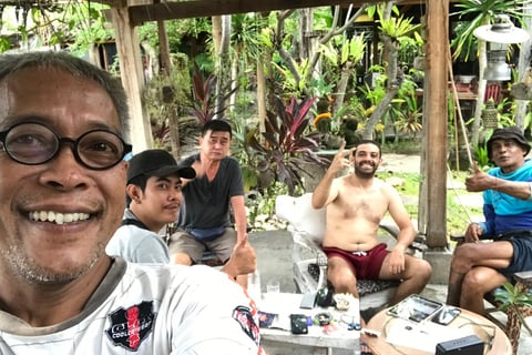 a man with glasses and a white shirt is taking a selfie