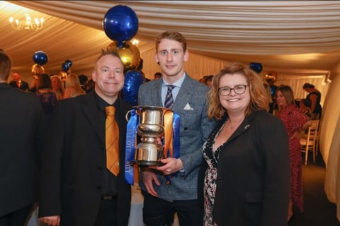 Elliott Hewitt receives the SSA Player of the Year 22/23 from Dean and Cheryl Foulkes