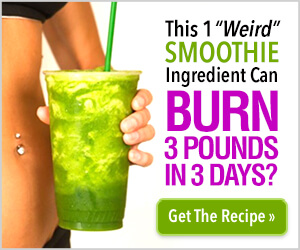 a woman holding a green smoothie in front of her stomach