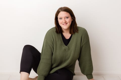 a woman sitting on the floor with her feet on the floor