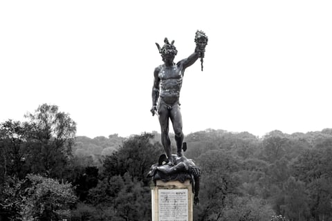A Statue of Perseus holing the head of medusa in black and white