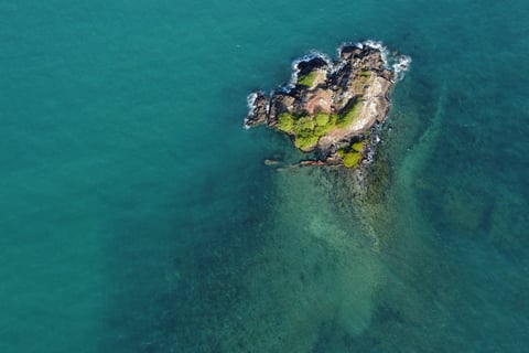 a small island with a small island in the middle of the ocean