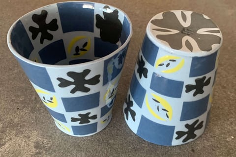 Blue and black cups with patterns inside and out