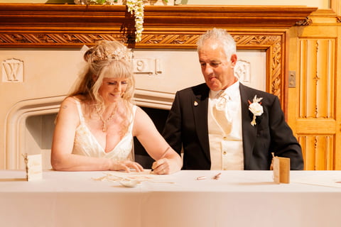 Couple Signing Certificate At Their Tying The Knot Ceremony