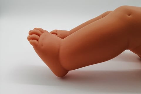feet of a Miniland doll