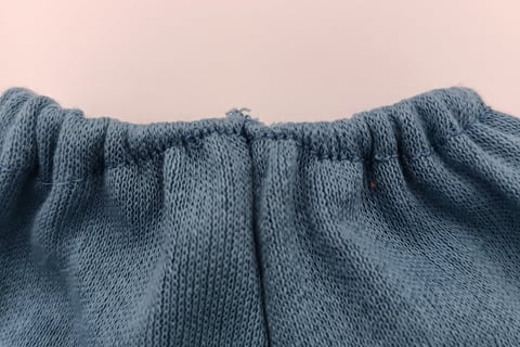Flaw in elastic waistband of trousers