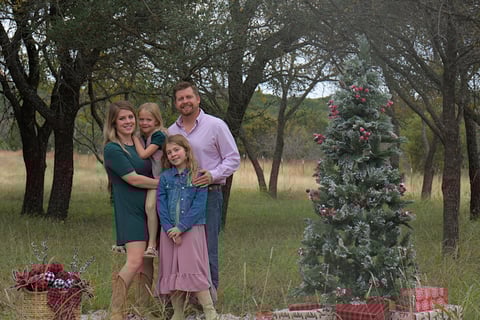 family with Christmas tree prop outdoor photo session near Dallas Fort Worth DFW area, Texas