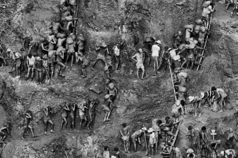 a group of people standing on a hill side
