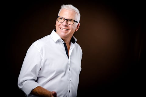 Martin in a white shirt and black tie dye