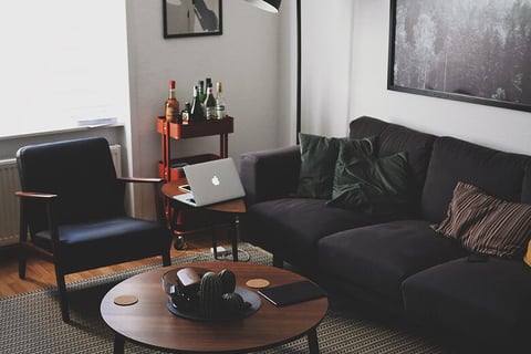 Bright living room with open laptop