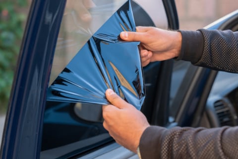 a person holding a piece of paper with a blue triangle