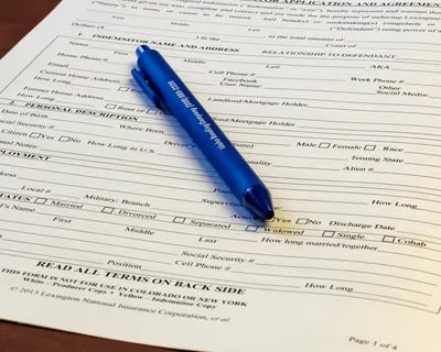 Bail bond application sitting on a table with a pen.