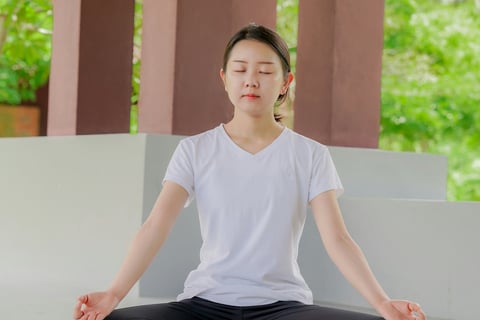 a woman sitting in a yoga pose