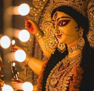 Durga Maa in a costume with a candle lite up