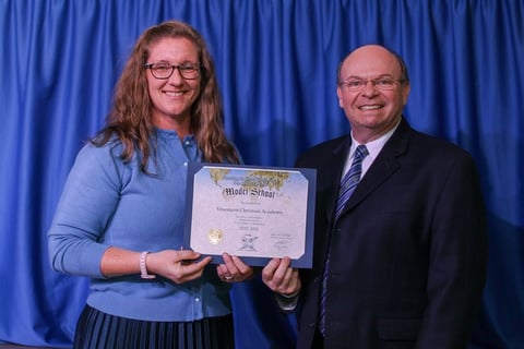 Mrs. Kori Dawson and Bro. Howard presenting VCA with Model School Status