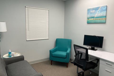 Office with chair, desk and sofa with rainbow and bridge wall art