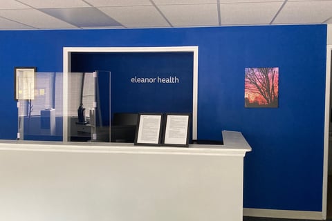 Eleanor Health front desk with tree with sunset wall art