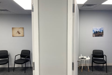 exam rooms with chairs and wall art of dragonfly and brooklyn bridge