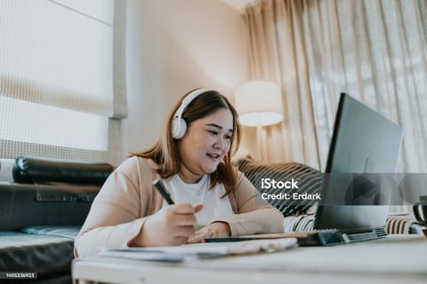 a woman sitting on a couch with headphones on her head