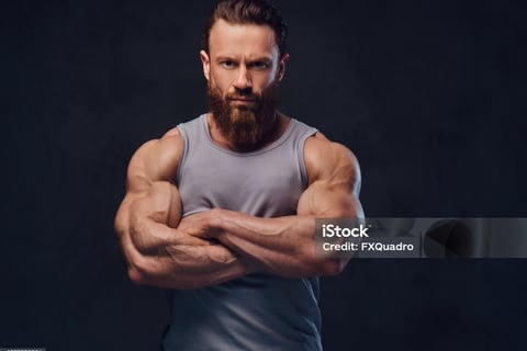 a bearded man with muscles