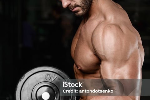 a man with a dumbbell in his hand