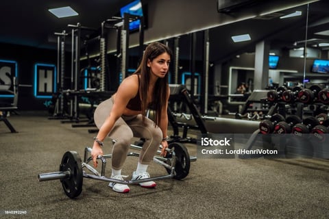a woman using a trap bar for exercise 