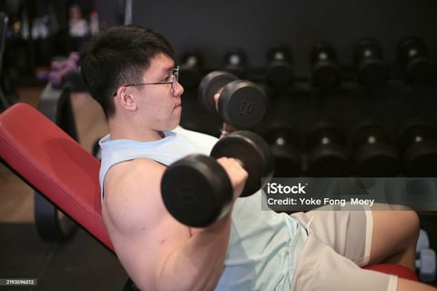 man doing curl exercise on bench